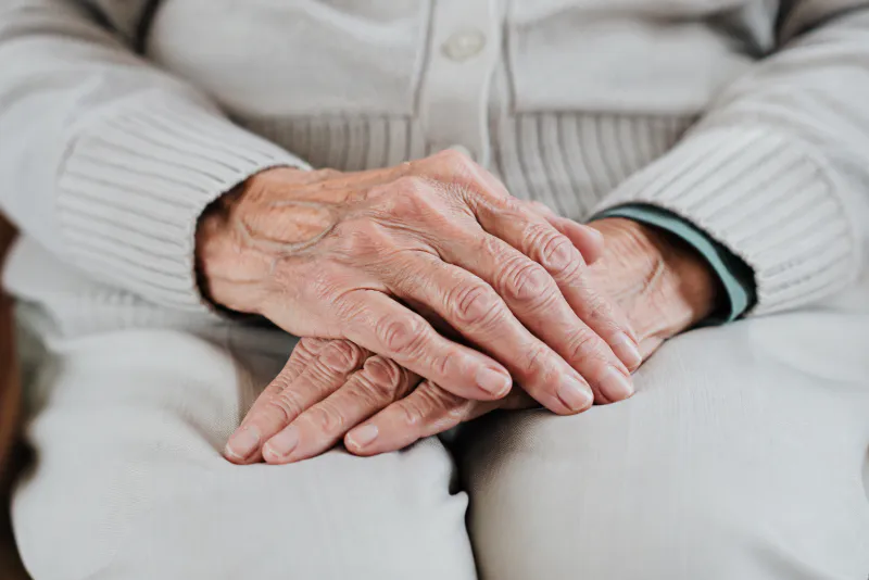 Caregiver assisting an older nursing home resident